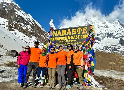 Guests posing at Annapurna base camp at sunrise