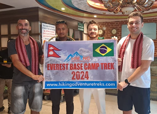 Group Posing with banner of Everest Base Camp Trek